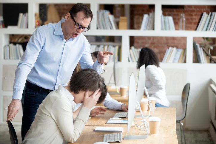 Furious businessman shout at female employee